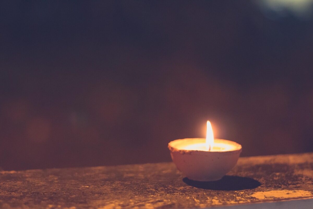 Lit tealight candles glowing in the dark