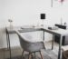 Compact home office workspace with desk, laptop and armchair