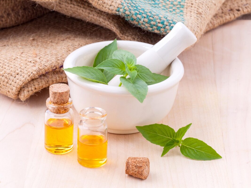 Waterless cold-air scent diffuser beside bottles of fragrance oil