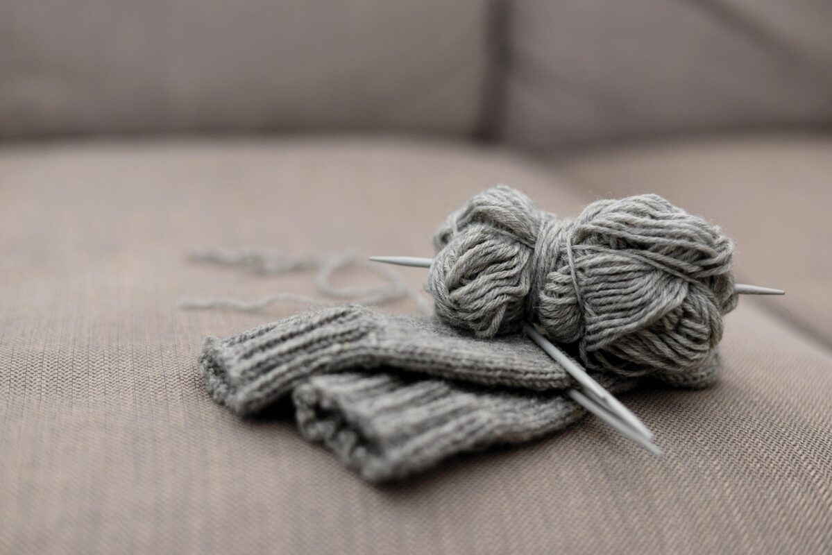 Hands knitting with wool