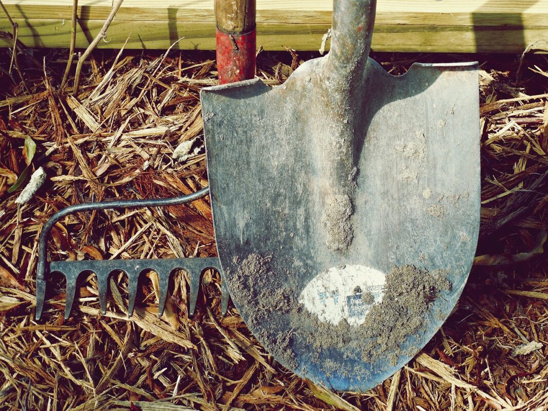 A garden shovel in freshly turned soil