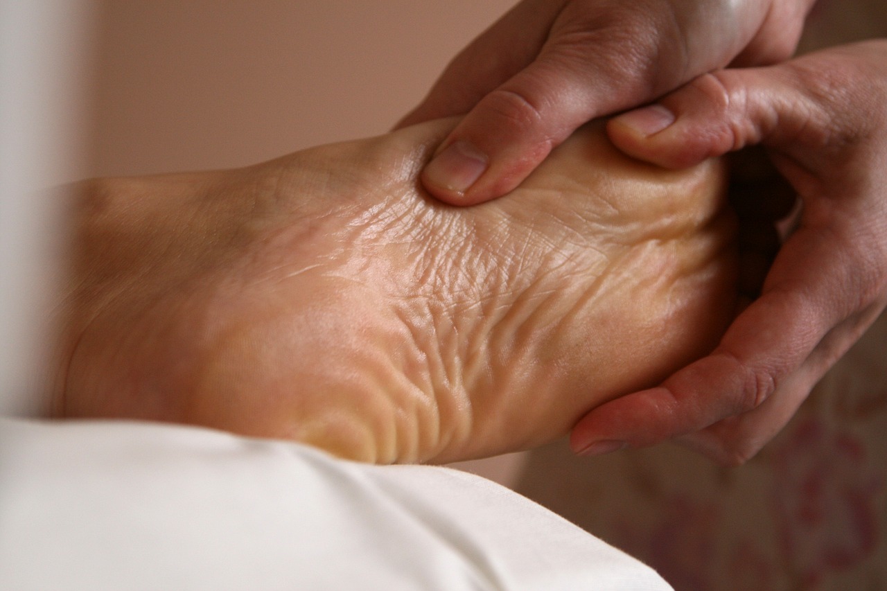 Spiky foot roller under the arch of a bare foot