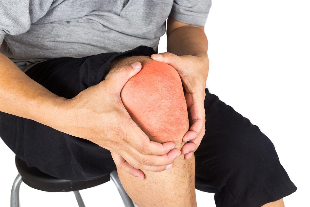 Using a percussion massager on a calf muscle