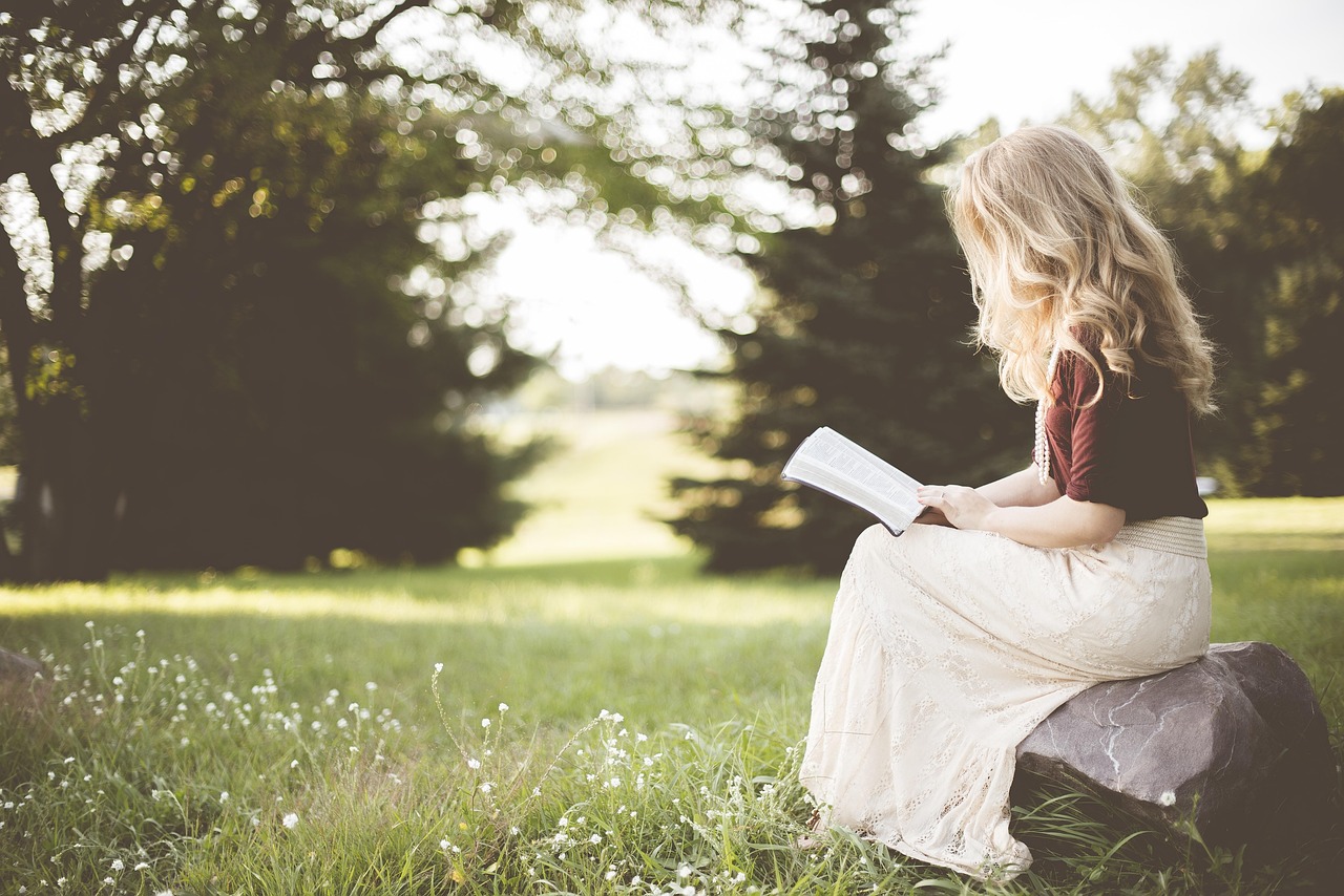 Person reading a book with notes in the margin