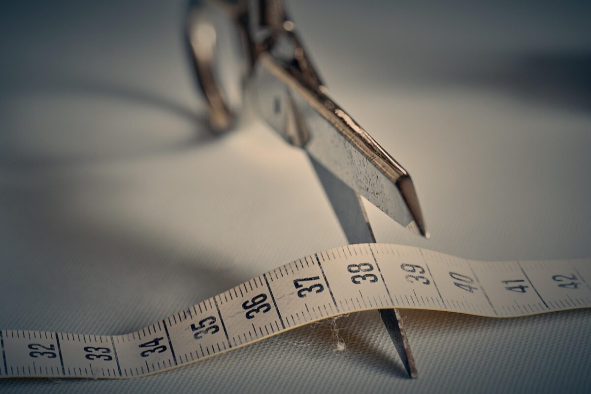 Measuring tape and scissors on a cutting table