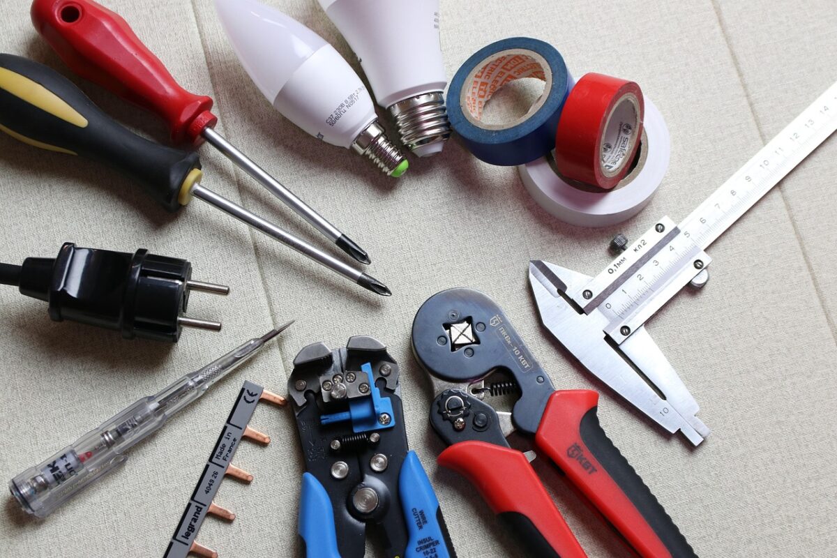 An electrician working with wiring tools