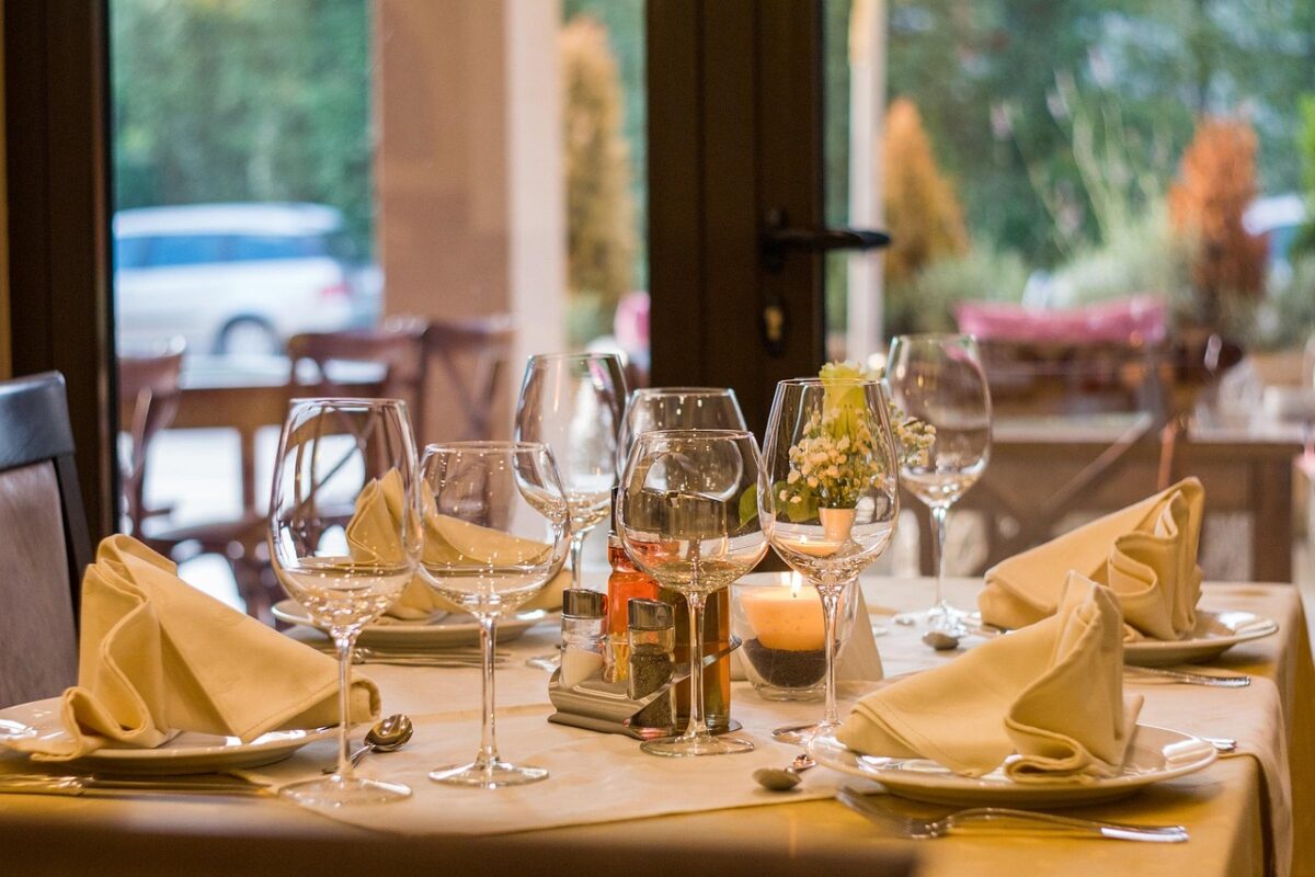 A restaurant table laid with glassware and cutlery