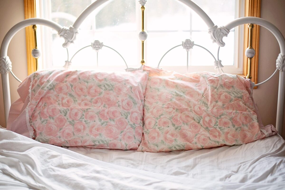 A softly made bed in the morning light